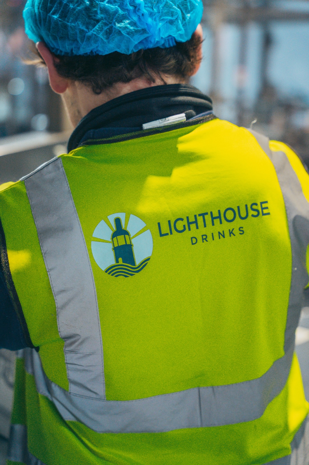 Lighthouse Drinks team member in branded high-vis on the bottling floor